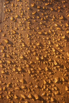 Wet wooden varnished board rain drops as background