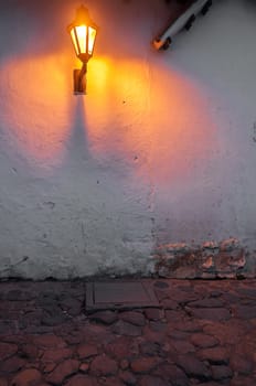 Street light in a colonial town with a cobblestone street