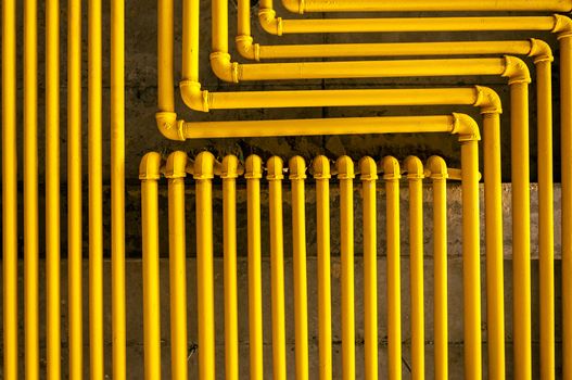 An image of yellow pipes forming an interesting pattern.