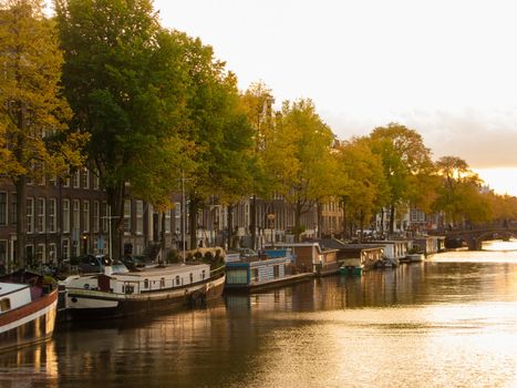 Amsterdam canal and boats with golden afternoon light
