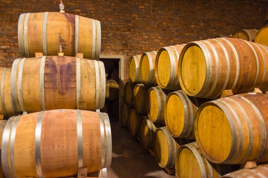 Barrels of South African wine in a wine cellar