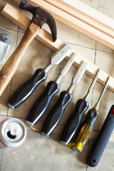 Selection of woodworking tools, wood, and beer can