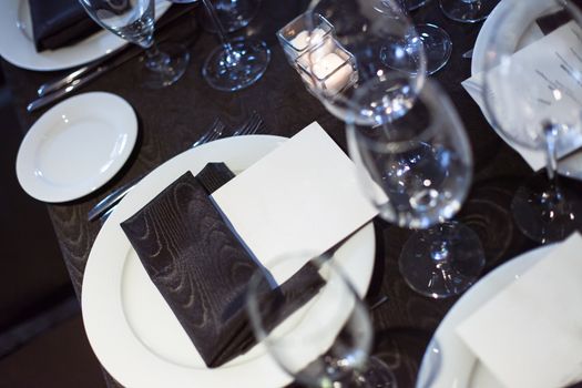 Blank card at restaurant dinner place setting