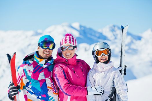 Happy smiling family in a ski outfit having fun on the winter vacation, Zellertal, Austria. Focus on the girl