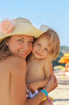 Happy mother and baby on the beach