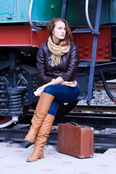 girl waiting for landing on the platform in the train