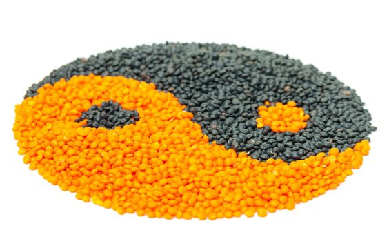 Orange and Black Lentil forming a yin yang symbol, isolated on white