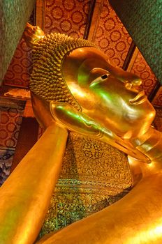 Face of reclining buddha statue at Wat Pho temple public place, Bangkok, Thailand