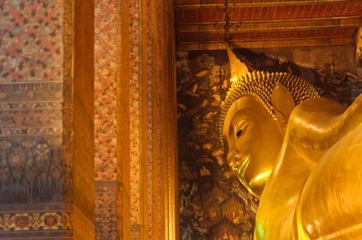 Face of reclining buddha statue at Wat Pho temple public place, Bangkok, Thailand
