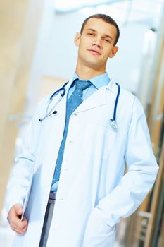 Portrait of friendly male doctor in hospital smiling