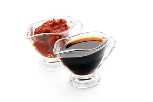 Soy and Ketchup Sauces in Glass Gravy Boat isolated on white background