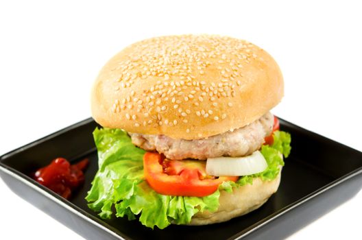 hamburger with tomato sauce on black dish