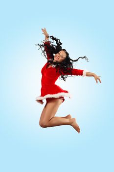 Happy smiling woman in red xmas costume jumping high