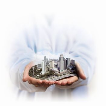 Image of a modern cityscape in the hand of a businessman