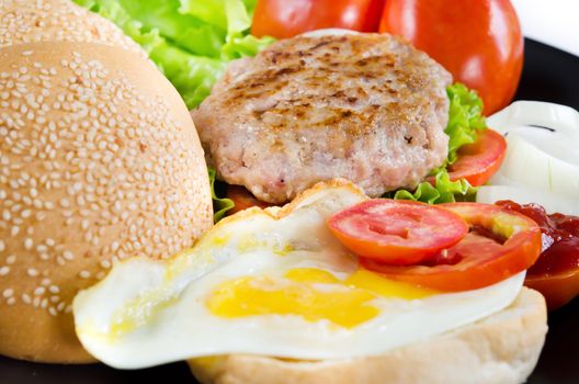 full breakfast with fried eggs, fresh vegetable , bread and fried pork