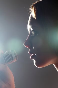 Portrait of female rock singer with microphone