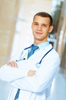 Portrait of friendly male doctor in hospital smiling