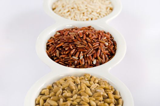 Grains Set ,  rice , red rice , wheat  grains on white bowl
