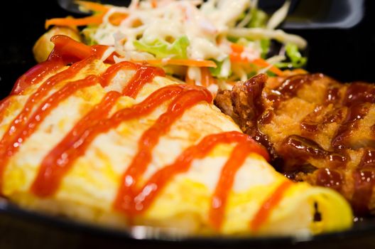 pork flavoured rice wrapped with fried egg and special sauce
