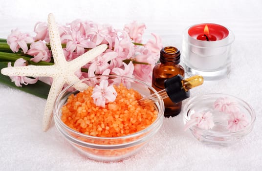 Relaxing and beautiful spa still life with candles, flowers and bath salts.