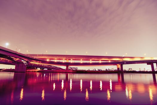 night highway with light reflections over Arakawa river in Tokyo Japan