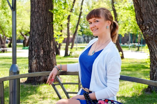 portrait of a beautiful woman, spending time in a summer park