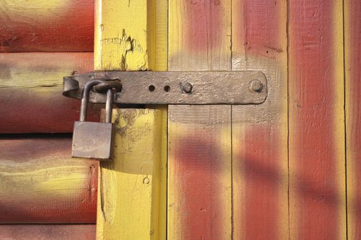 striped wooden door fragment with metallic lock