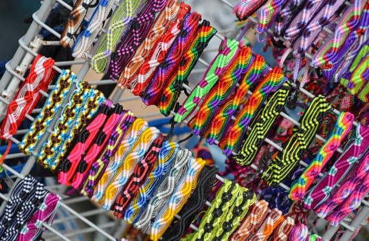 Colorful woven wristbands on display at market