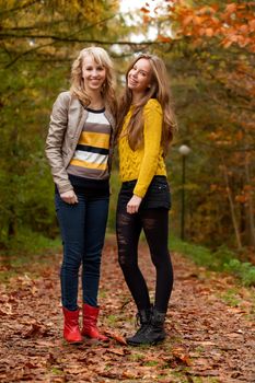 2 girls are having fun in the forest