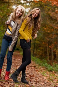 2 girls are having fun in the forest