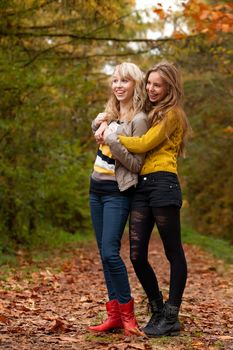 2 girls are having fun in the forest