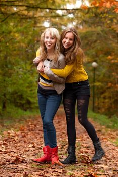 2 girls are having fun in the forest