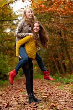 2 girls are having fun in the forest