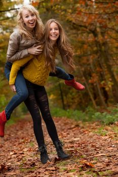 2 girls are having fun in the forest