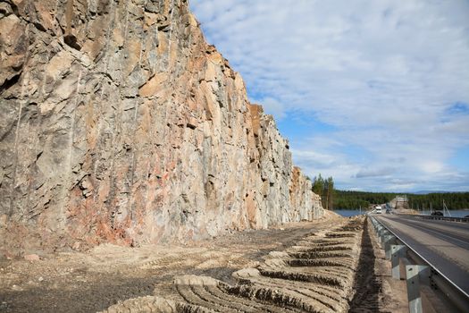 The road carved into the rock. Construction of roads in difficult circumstances through the rock in northern Russia