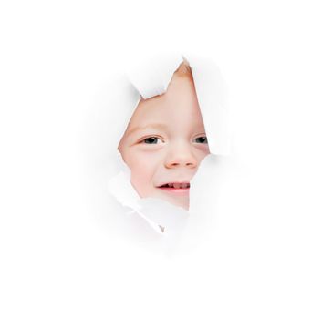 child looks in a hole in a sheet of a paper