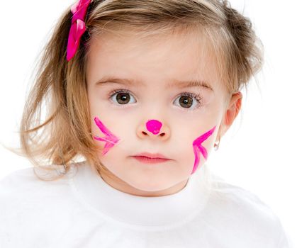 cute little girl with face in paint looks into camera