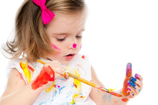 cute little girl with a brush and paints on white background