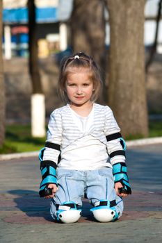 Little girl in roller skates at a park