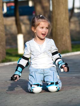 Little girl in roller skates at a park