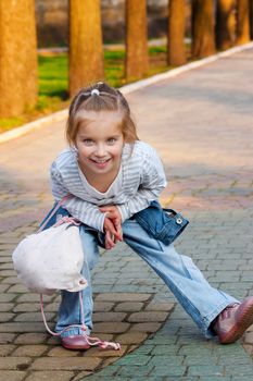 Cute little girl on outdoor playground equipment