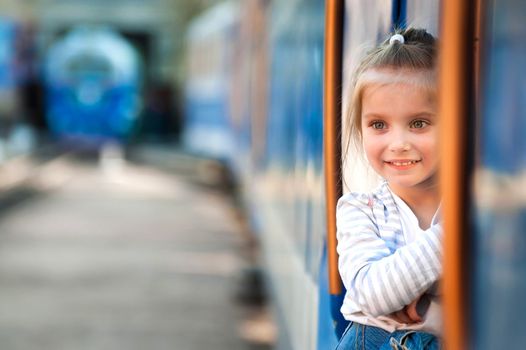 Smiling cute little girl with train