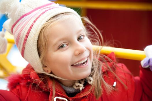 Smiling face of little girl on outdoor playground