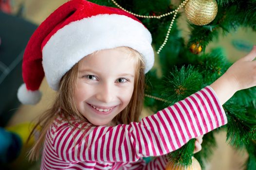 portrait of cute happy christmas child in santa hat closeup