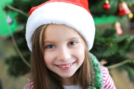 portrait of adorable happy christmas child in santa hat closeup