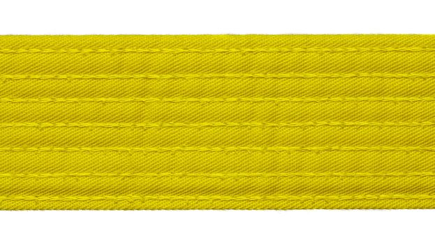 Karate yellow belt closeup isolated on white background
