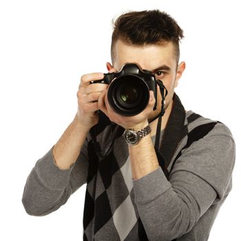 Young man with camera. Isolated over white background.