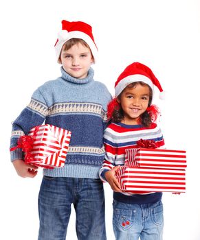 Smiling little mullato girl and her brather in Santa's hat with gift box, isolated on white