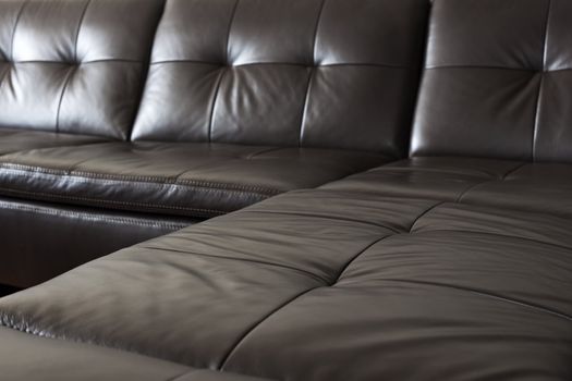 Closeup of luxurious expensive black leather couch