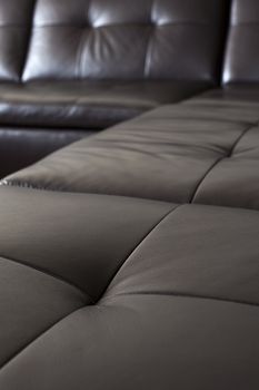 Closeup of luxurious expensive black leather couch